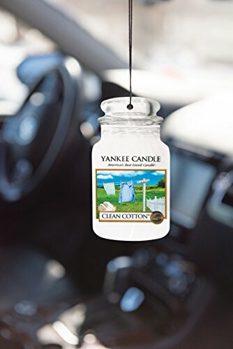 Yankee Candle Clean Cotton air freshener hanging in a car.