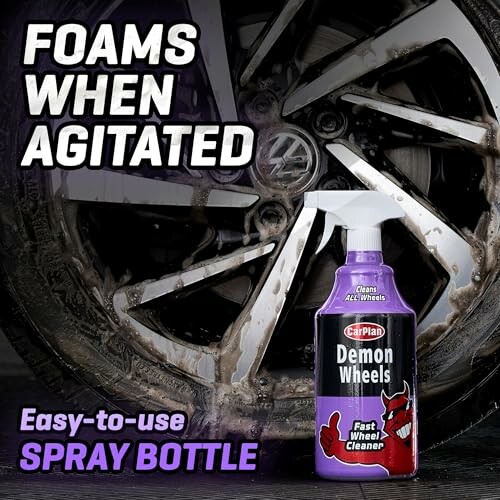 Demon Wheels cleaner spray bottle in front of a foaming car wheel.